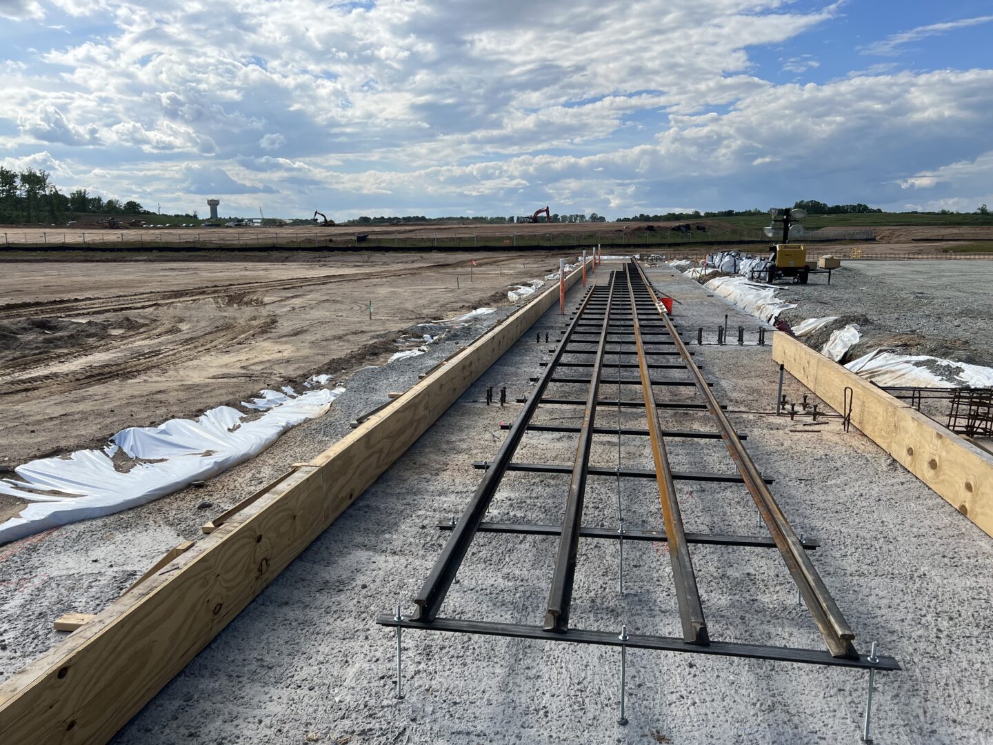 May 2023: Foundation rails are placed for the Boom Supersonic Superfactory.