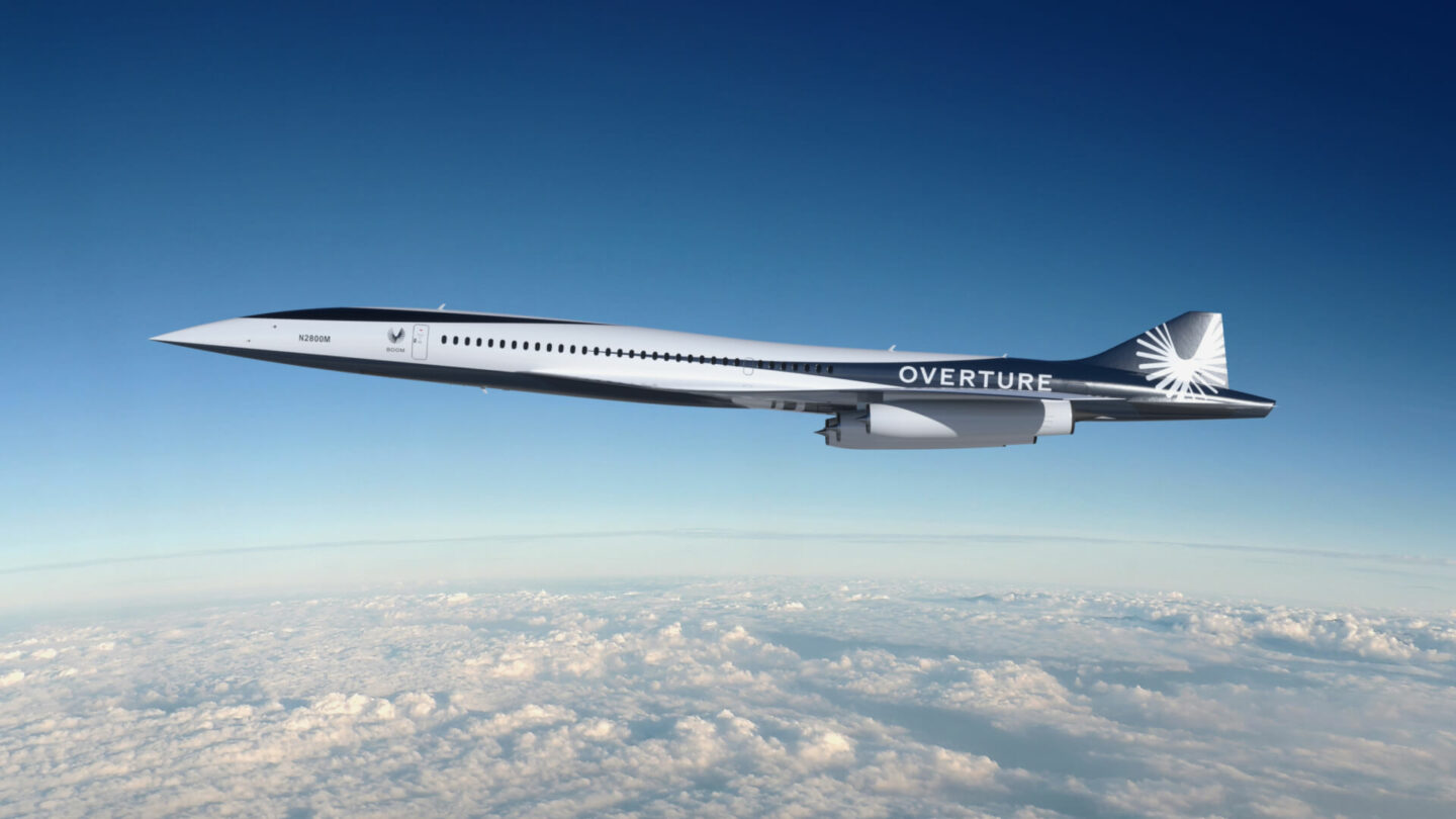 Overture, Boom's sustainable supersonic airliner, built for speed, safety, and sustainability, in flight over the clouds.